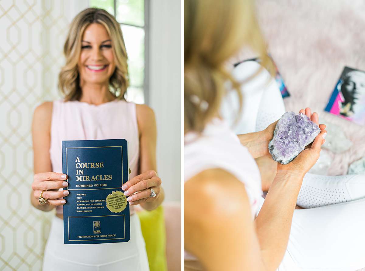woman business owner holding a book and crystal
