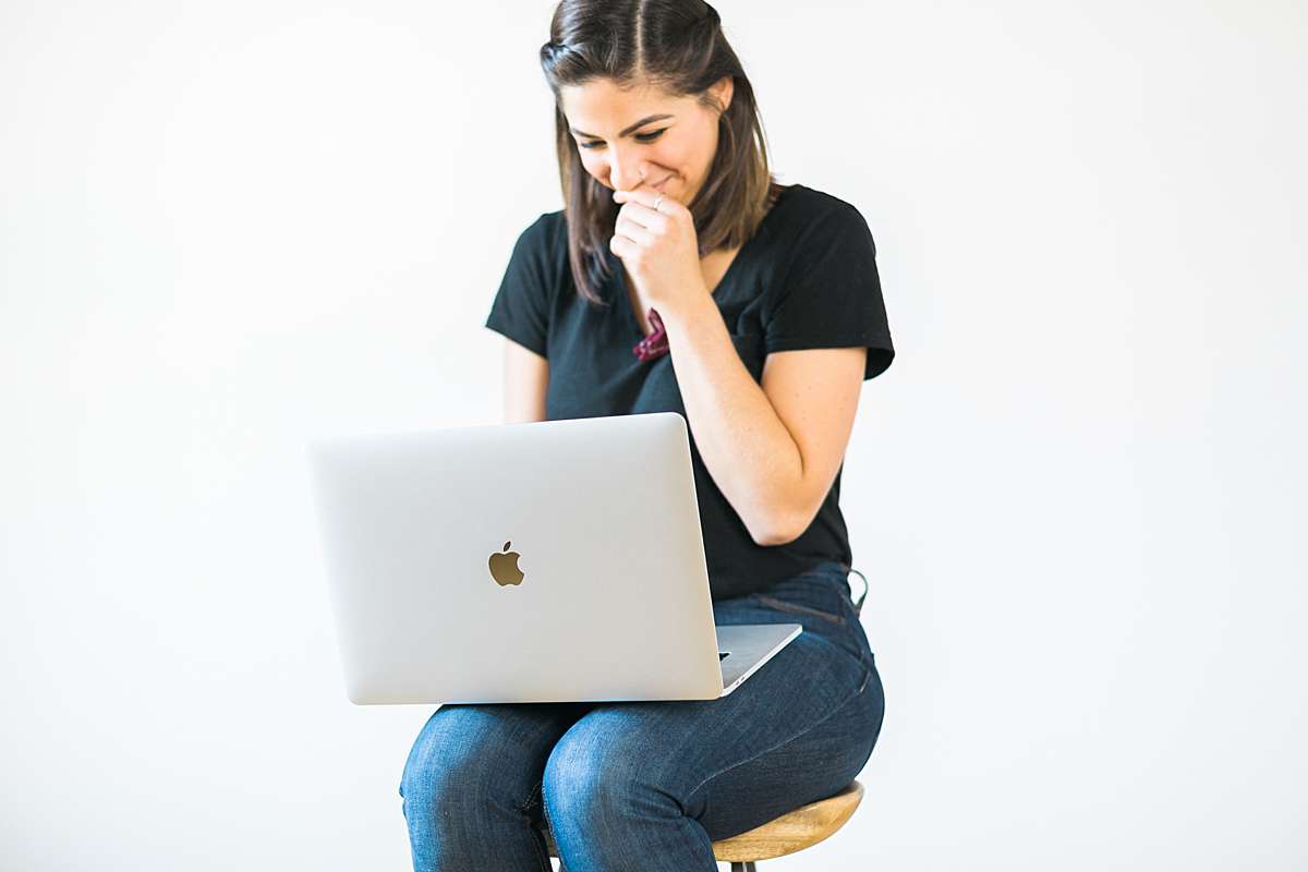 website designer on her macbook apple laptop