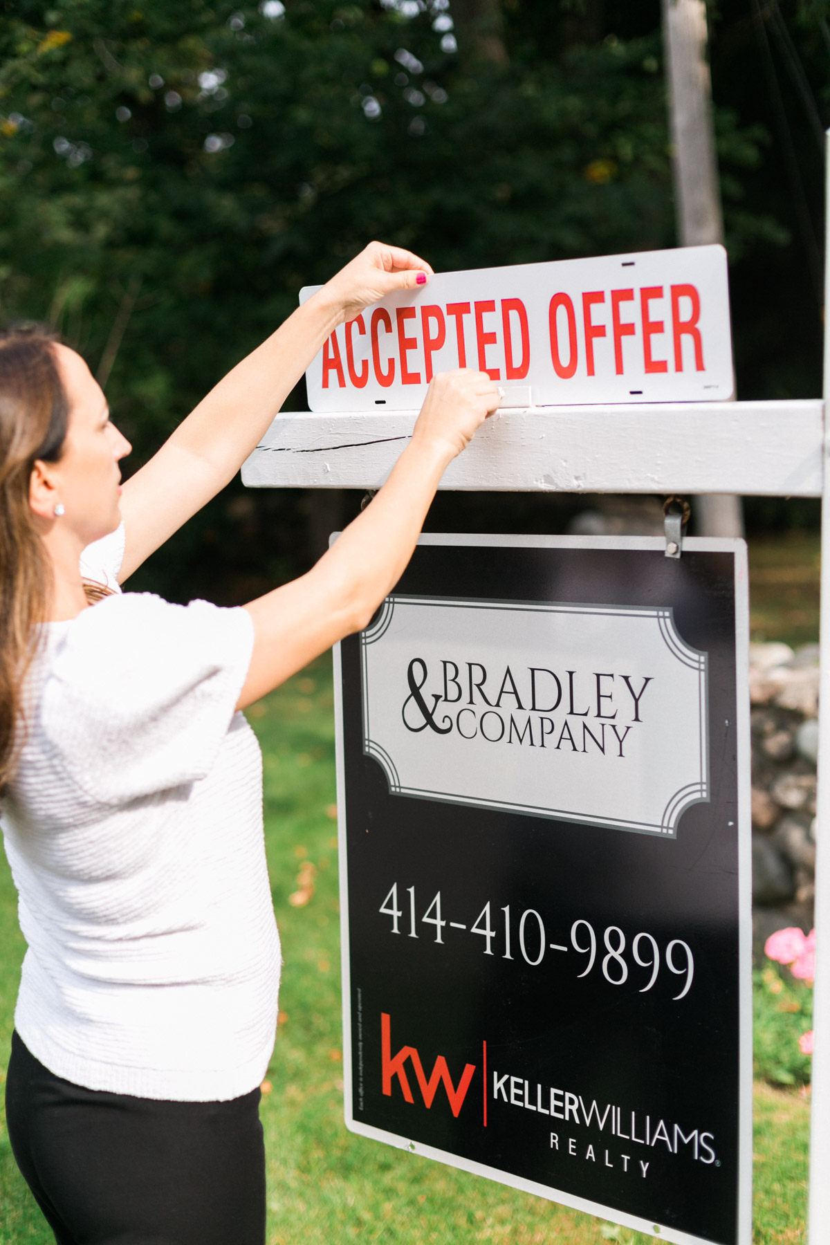 real estate agent by offer sign