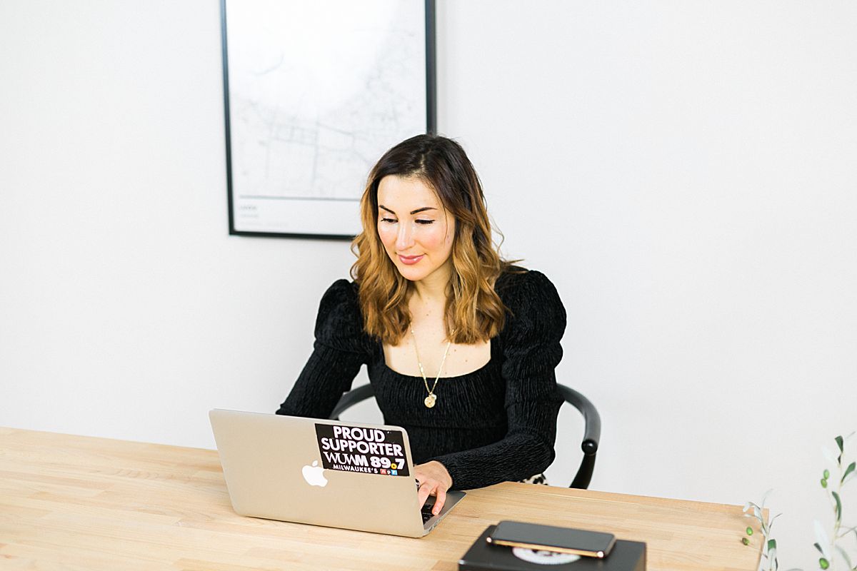 woman business coach working at laptop and minimalist desk