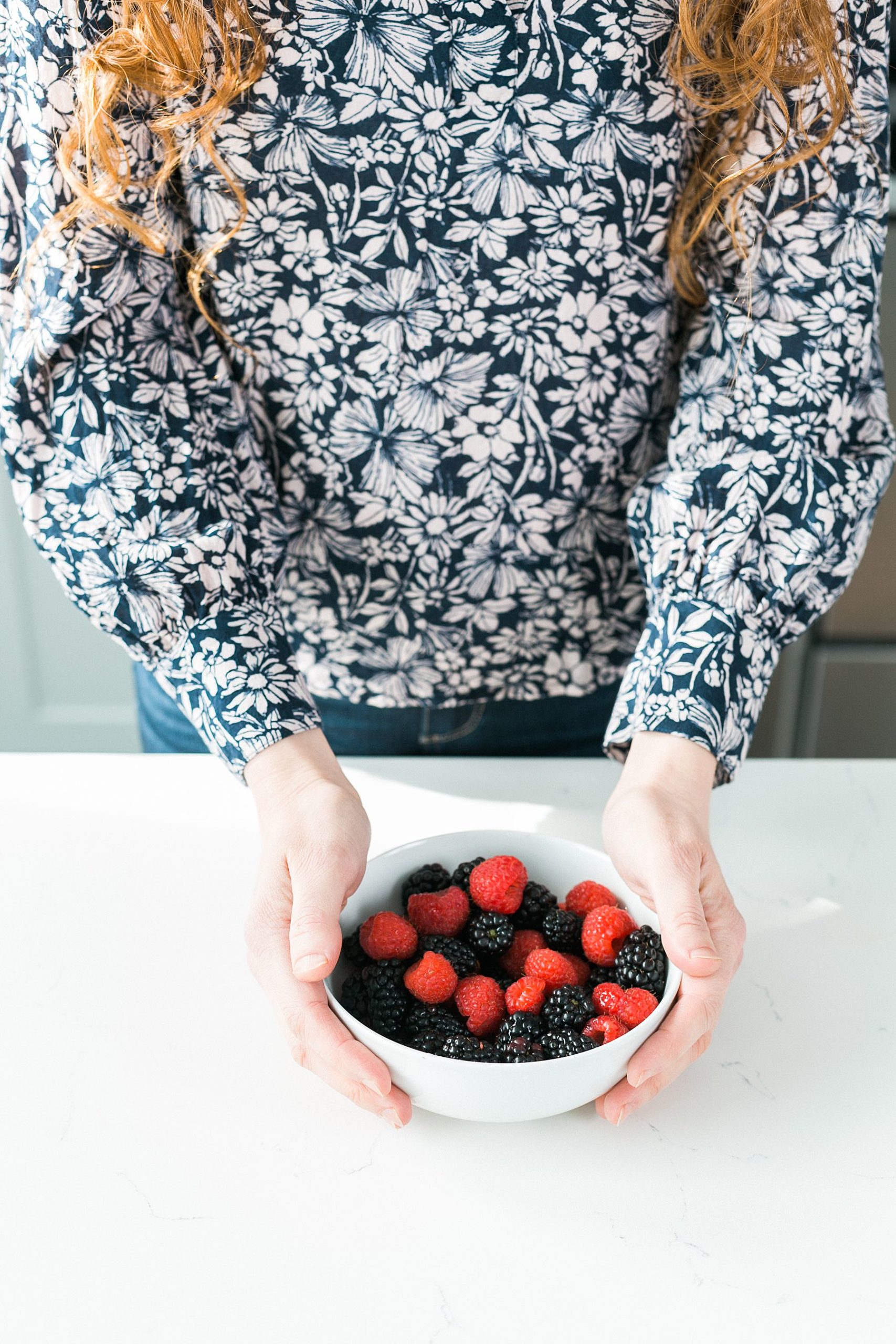 wellness coach holding a bowl of berries
