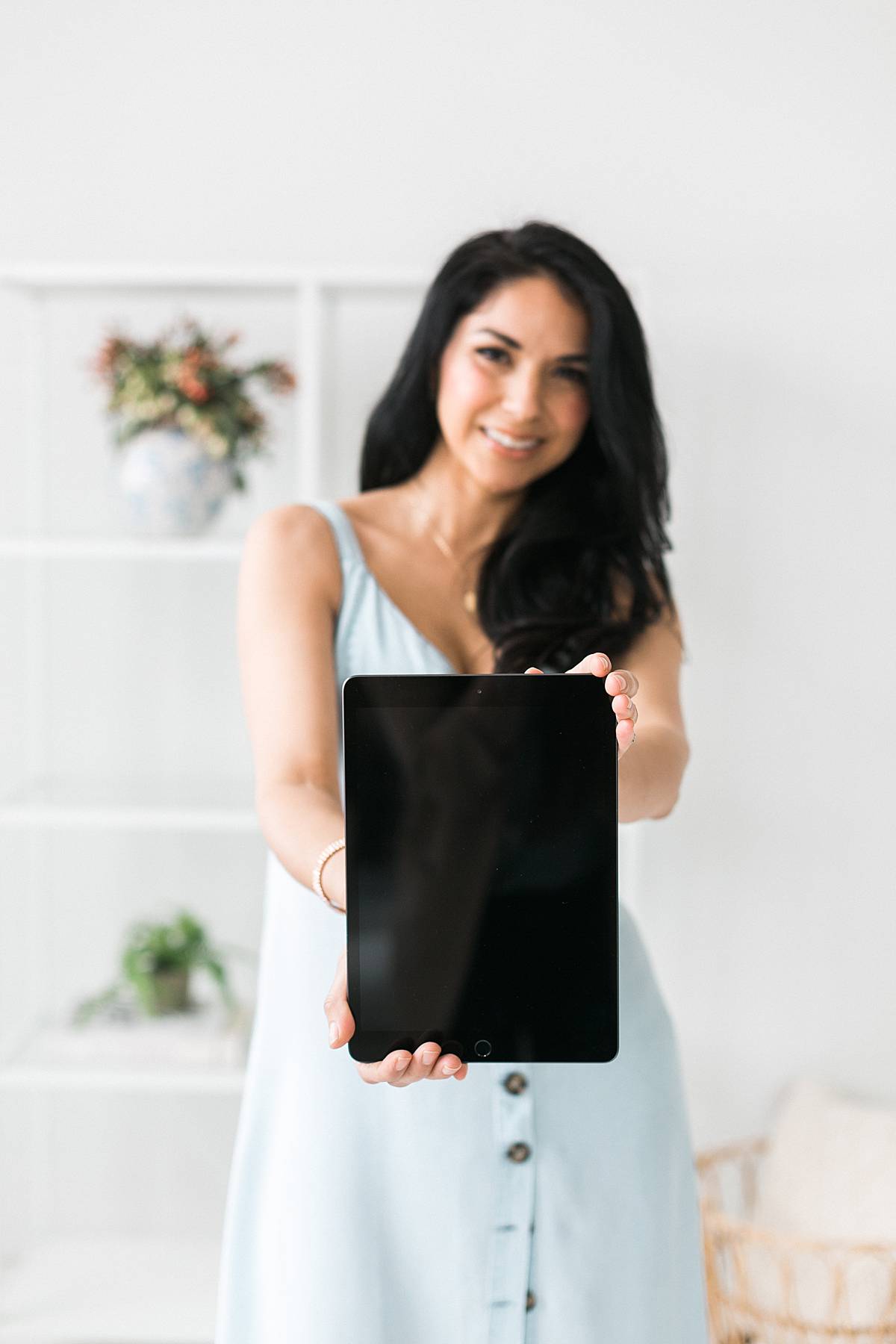 woman holding a tablet ipad