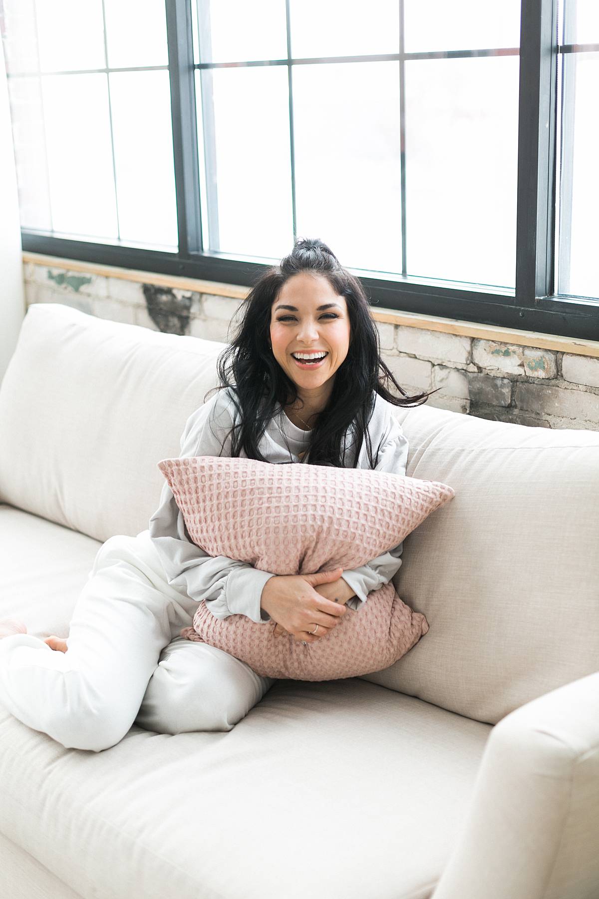 woman headshot cozy on couch