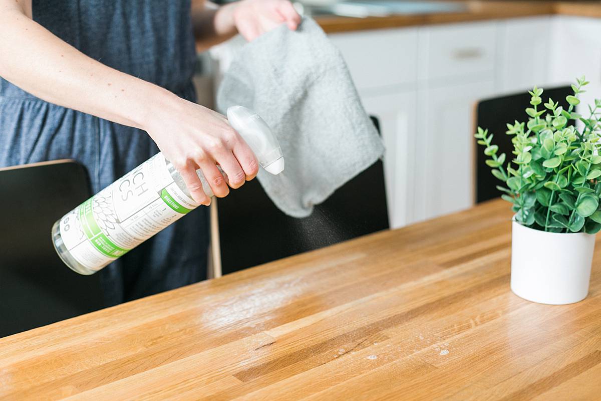 organic blogger using green cleaning products in kitchen