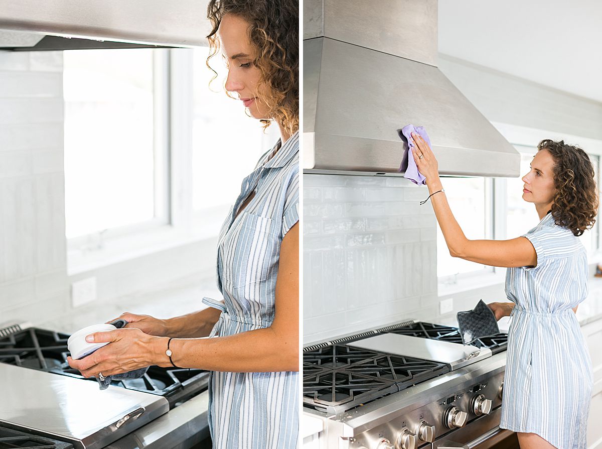 woman cleaning stove vent hood