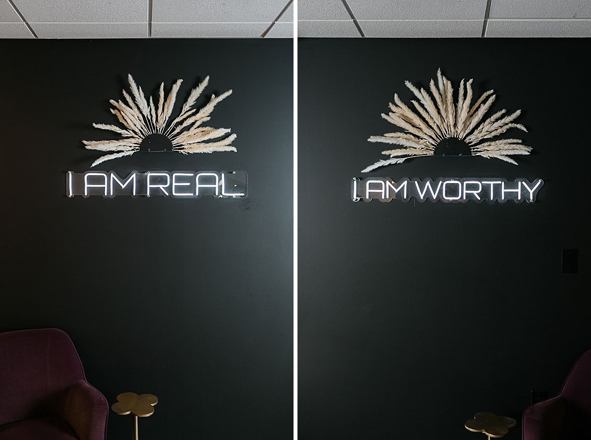 neon wall signs at blow dry bar that read "i am real" and "i am worthy"