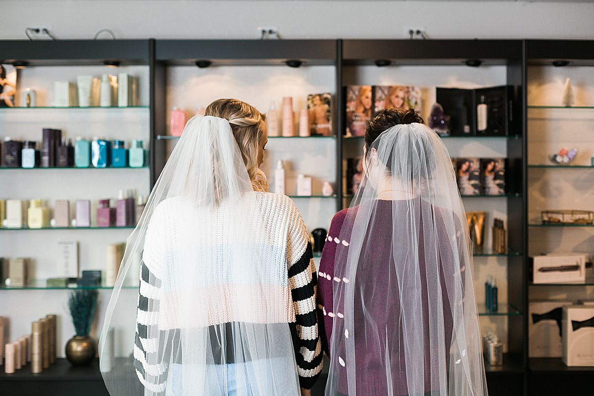 bride at salon with hair styled and veil
