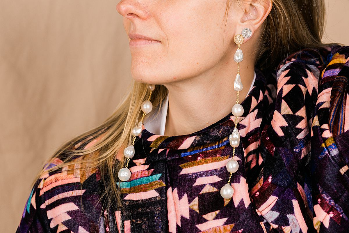 long pearl earrings and southwest style coat