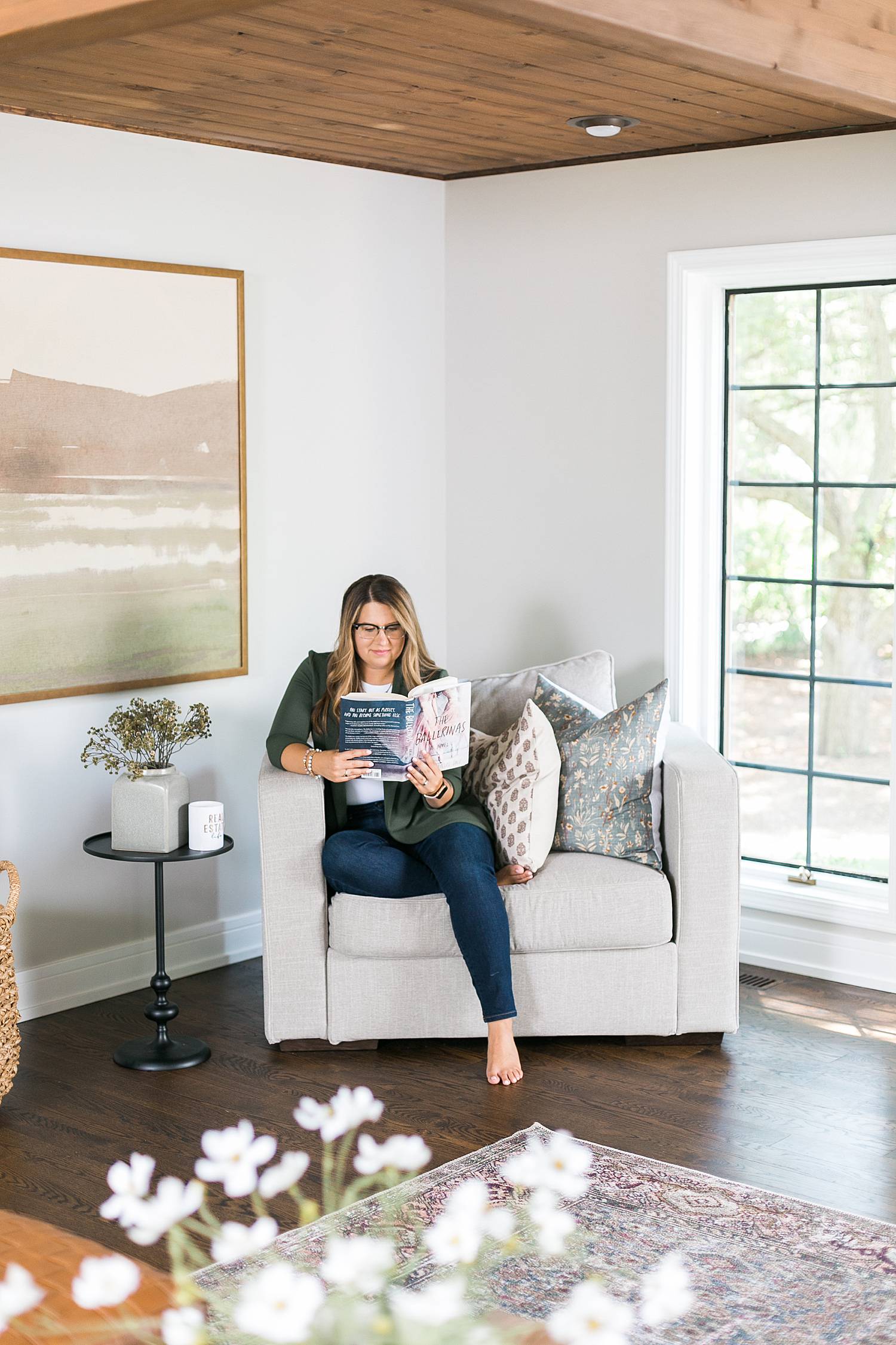 real estate agent reading a book in the living room