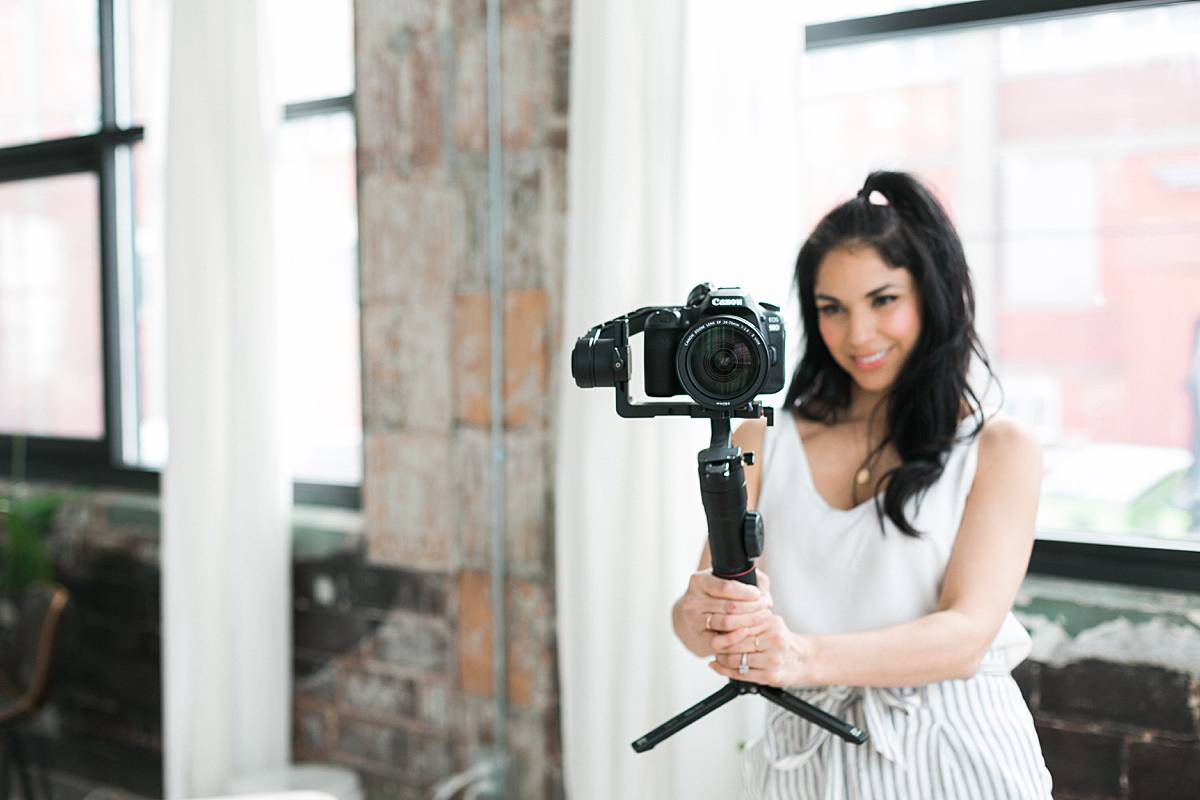 woman videographer holding camera