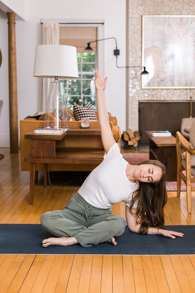 woman doing yoga in living room space
