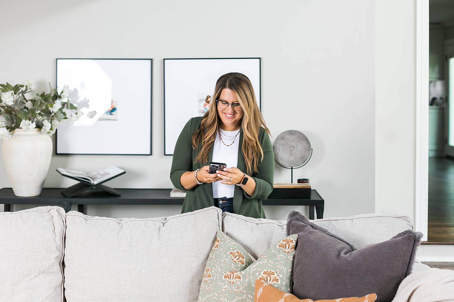 realtor working on her phone from living room