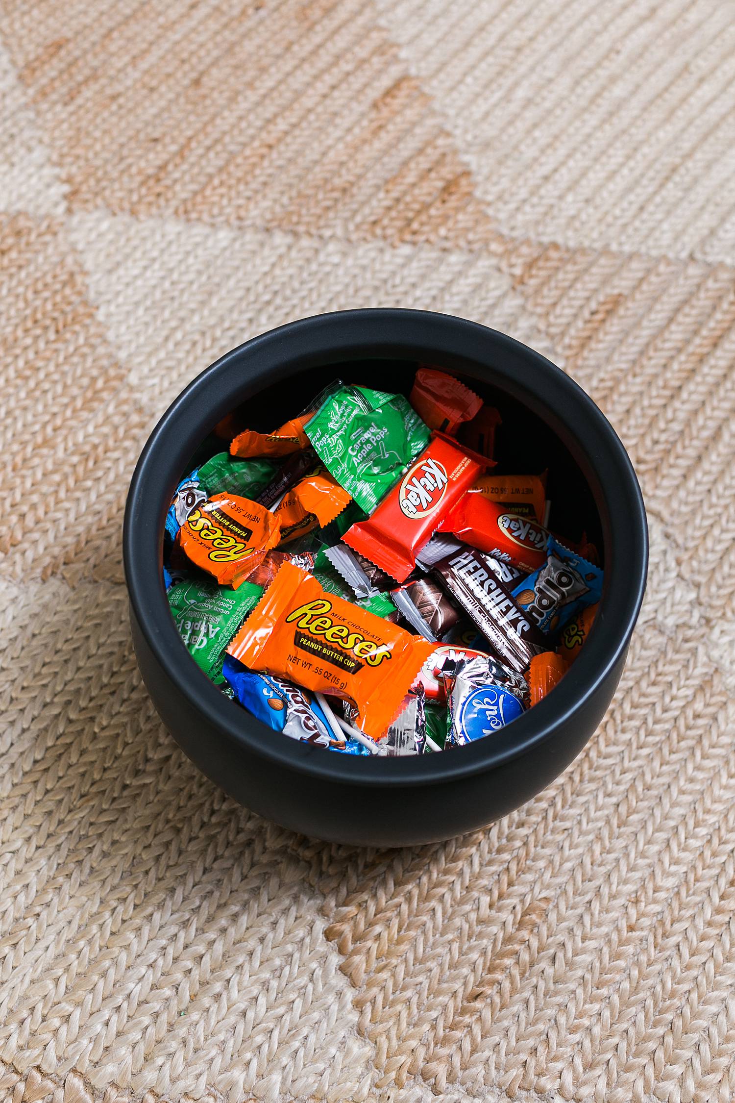 halloween candy in crate and barrel cauldron on a diamond checkered rug