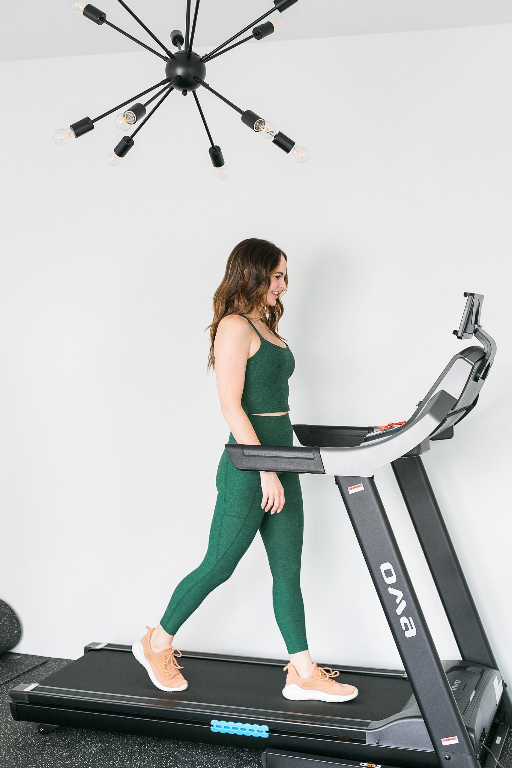 wellness and fitness coach on treadmill in home gym Chicago