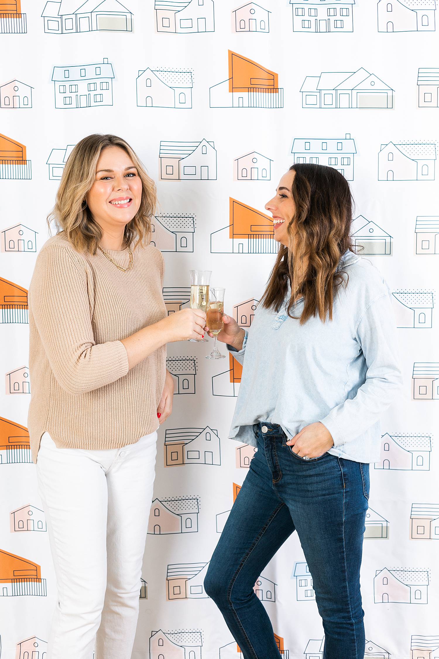 women real estate agents on closing day toasting flutes of champagne