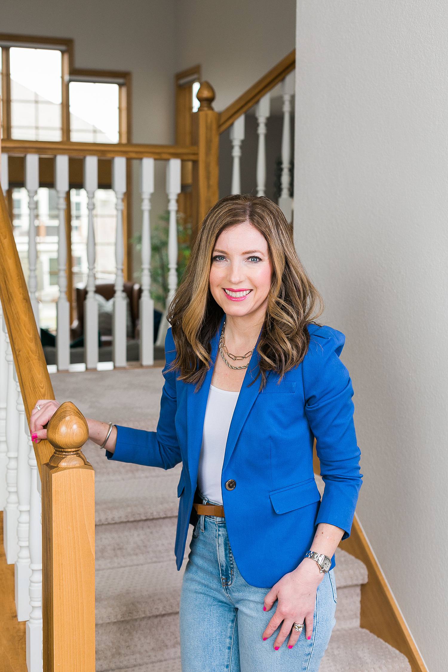 woman headshot for image consultant wearing a bright blue blazer and denim jeans