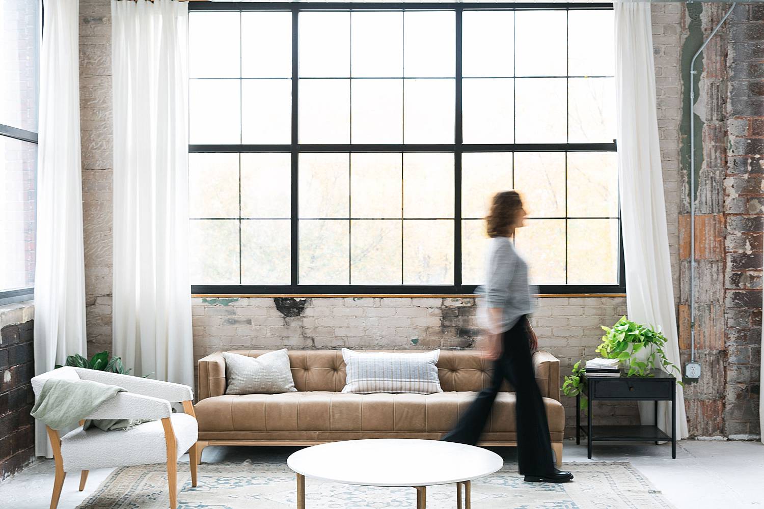 woman walking in photo studio living room with movement motion blur
